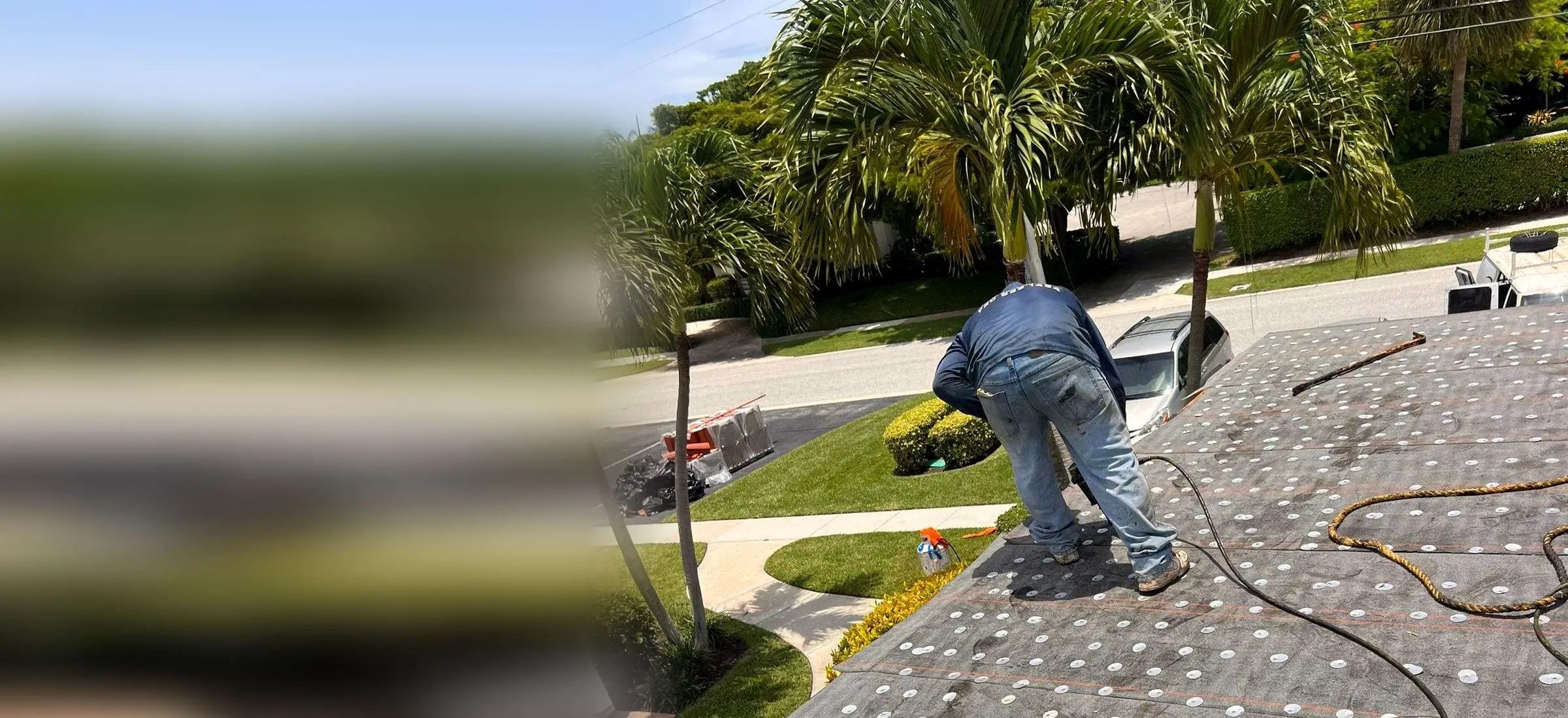 PSR crew member fastening underlayment on a roof, with palm trees and a residential street behind
