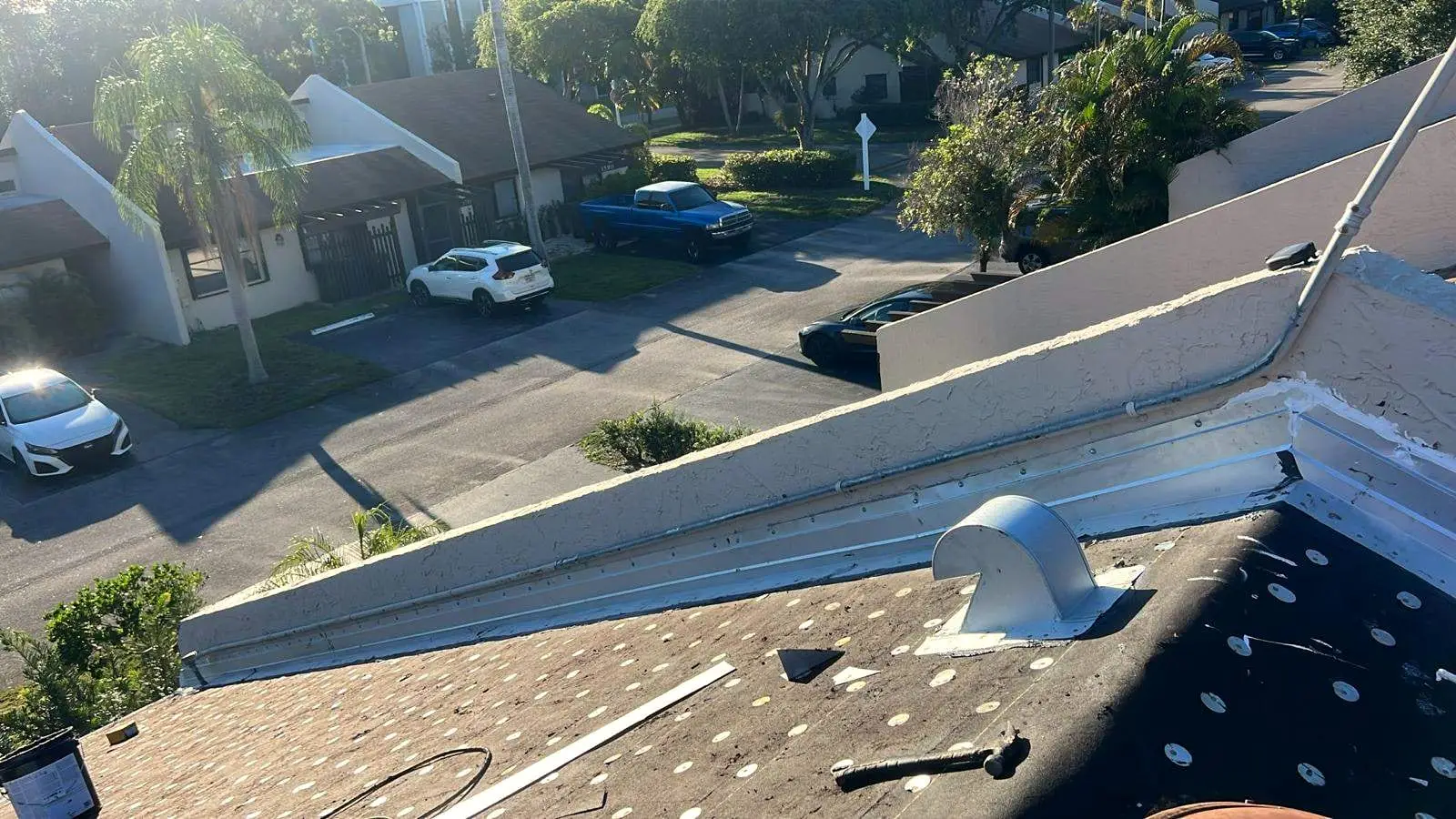 Cap-nailed underlayment and new metal flashing around a roof vent